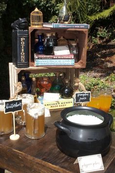 a table topped with lots of different types of drinks and books on top of it