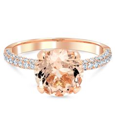 an oval cut peach morganite and diamond ring in rose gold with diamonds around the band