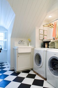 a washer and dryer in a room with black and white checkered floor