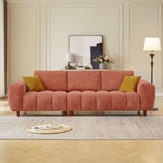 a living room scene with focus on the couch and floor lamp in the foreground