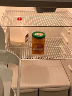 an open refrigerator filled with lots of food and condiments on the bottom shelf