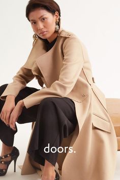 While revisiting the famous trench coat, the designer gives her own version with all the hallmarks of the original including military-inspired epaulettes and featuring tortoiseshell buttons in a woven version. Mid-calf length. Layered trench coat featuring long sleeves, a front button fastening. Layered collar detail. Side flap pockets. Asymmetric hem draping down either side. Designed by GR LONDON PARIS, a young London based Fashion House. Grab this coat at doors.nyc and #supportTALENT Double Breasted Trench Coat, Cape Coat, Oversized Coat, Military Inspired, Puffer Coat