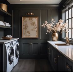 a washer and dryer in a room with black walls