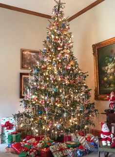 a decorated christmas tree with presents under it