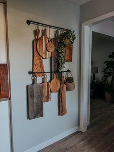 several wooden cutting boards hanging on a wall