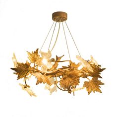 a gold chandelier with flowers hanging from it's center and two lights on each side