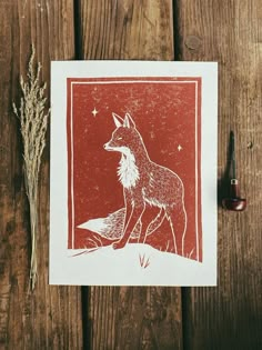 a red and white card with an image of a fox sitting on top of it