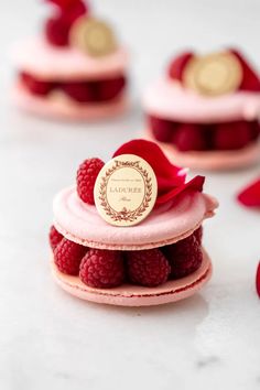 raspberries are placed on top of small cakes