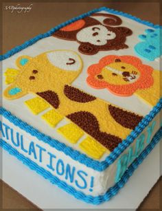 there is a cake with animals on it and the words congratulationss written in blue