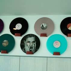 there are many different colored records on the wall