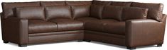 a brown leather sectional sofa sitting on top of a white floor