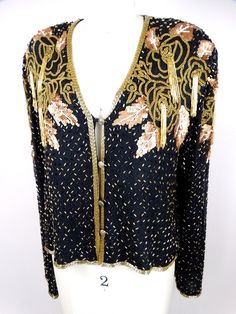 "This is an elegant vintage piece hand sewn with beading and sequins and in excellent condition! There are 4 closures and measurements are taken while all are intact. Size MEDIUM measurements: Bust - 38\" Shoulders - 16\" Sleeves - 25\" Length - 20\" Tag Size - Medium Size LARGE measurements: Bust - 42\" Shoulders - 18\" Sleeves - 25\" Length - 21\" Tag Size - Large All of my items come from a smoke-free and pet-free home. If you have any questions, please don't hesitate to ask!" Vintage Sequined Formal Outerwear, Vintage Gold Long Sleeve Outerwear, Vintage Sequin Jacket, Vintage Bolero, Vintage Beaded Long Sleeve Outerwear, Vintage Black Embellished Outerwear, Checkered Jacket, Bolero Shrug, Sequin Jacket