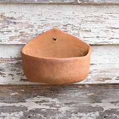 a clay bowl sitting on top of a wooden table