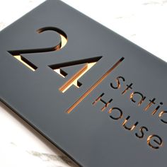 a close up of a metal sign on a marble surface with the letters k2 studio house