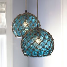 two blue glass balls hanging from a ceiling