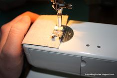 the sewing machine is being used to sew something on it's side,