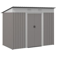 a gray and white shed with two doors