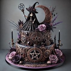 an elaborately decorated cake with candles and decorations on it's sides, including a witch figurine