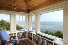 an image of a room with bookshelves and ocean view in the background on instagram