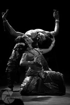 a man and woman dance together in the dark