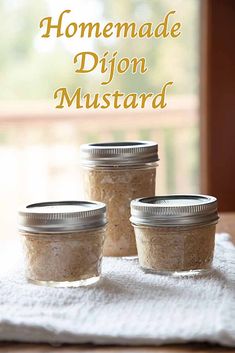 homemade dijond mustard in jars sitting on a towel with the words homemade dijond mustard