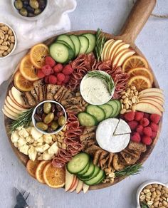 a platter filled with fruits, vegetables and crackers