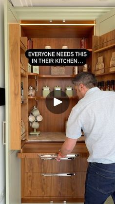 a man is opening the drawers in his kitchen