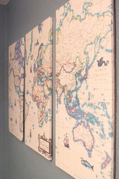 three maps are hanging on the wall