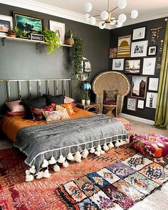 a bed room with a neatly made bed and lots of pictures on the wall