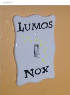 a white light switch with the words lumos nox on it's side