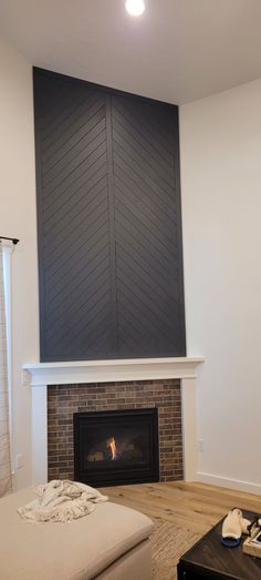 This fireplace focal point was designed by me and created by my husband using 3.5" MDF boards from Home Depot. Now needing to find farmhouse decor to go with our modern farmhouse theme. Chevron Wood Fireplace Wall, Chevron Shiplap Wall, Chevron Shiplap Fireplace, Chevron Fireplace Wall, Chevron Accent Wall, Chevron Fireplace, Mac Desk, House Diys, Reclaimed Wood Fireplace