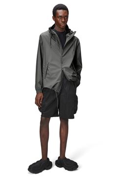 This lightweight, waterproof jacket with a longline silhouette keeps minimalism at the forefront as it keeps you dry. A hood with a built-in cap, an adjustable hemline and underarm eyelets bring comfort and breathability to the design that closes with a two-way, waterproof zipper. 30" length (size Medium) Hidden two-way front-zip closure Drawstring hood Long sleeves with elastic cuffs Unlined 100% polyester Machine wash, dry flat Imported Spring Waterproof Parka For Streetwear, Modern Waterproof Raincoat For Spring, Spring Windbreaker With Adjustable Hood For Rainy Weather, Casual Raincoat With Detachable Hood For Rainy Season, Casual Raincoat With Detachable Hood, Modern Waterproof Windbreaker For Fall, Modern Waterproof Windbreaker For Outdoor, Casual Parka With Detachable Hood For Rainy Season, Modern Hooded Raincoat For Spring