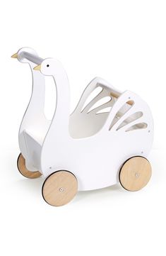 a white wooden duck toy with wheels