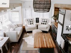 a living room filled with furniture and a wooden table in front of a kitchen area