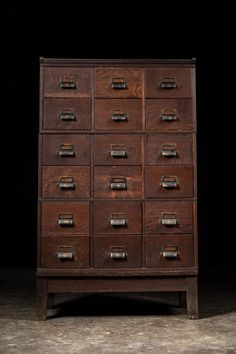 an old wooden cabinet with many drawers