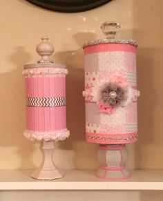 two pink lamps are sitting on a shelf