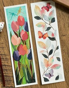 two bookmarks with watercolor flowers and dragonflies on them next to a pencil