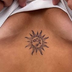 a woman with a sun tattoo on her back