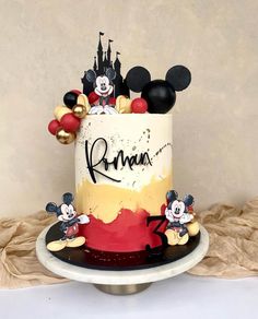 a birthday cake with mickey mouse and other disney characters on the top is ready to be eaten