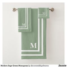 the monogrammed towels are green with white stripes and two matching letter m on them