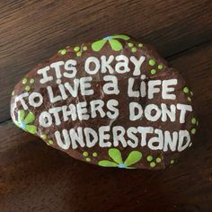 a rock with the words it's okay to live a life others don't understand