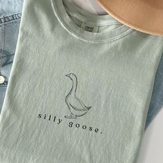 Silly Goose Shirt Silly Goose Tshirt Comfort Colors Silly Goose Vintage Farm Shirt Cute Goose Shirt Gifts for Farm Girls Mom Gifts Homestead This Comfort Colors shirt  features a simplistic graphic of a vintage-style drawing of a goose and the words "silly goose." below. Available in bay, blue jean, white, and mustard. If you are interested in long sleeve, go here: https://withawildflowerllc.etsy.com/listing/1741662335 ✿ The With A Wildflower mission is to give God the glory and give back throug Cute Goose, Silly Goose, Vintage Farm, Farm Girl, Mom Gifts, Comfort Colors Tee, Girl Mom, Graphic Tees Women, Cute Shirts