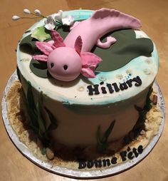 a birthday cake decorated with an image of a pink sea horse