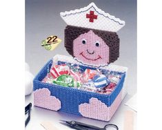 a cross stitch pattern for a nurse's box with scissors and pins on it