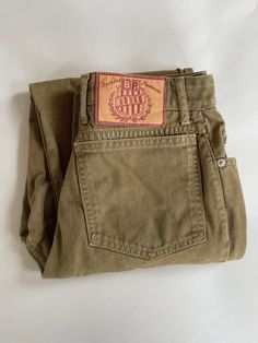 Olive green denim high rise, tapered leg Bongo jeans.  All cotton, made in USA.  5 pocket, zip fly.  Excellent condition. Vintage size 9.  Fits a waist size of 28" or a modern size 6. Waist 14" (28" waist) Hip 18.75" (37.5") Upper thigh 11.125" (22.25") Ankle 6.25" (13") Front Rise 12" Inseam 29.25" At this time standard shipping is a flat fee to the United States only.  Additional items ship for only one dollar.  To place an order to outside the US, please send me a message and I will reserve a listing for you with a custom shipping price.  Thanks for understanding!  Not responsible for lost or damaged packages, or customs fees.  Please see shop policies for additional information. Jeans Bongo, Bongo Jeans, One Dollar, Womens Jeans, Shop Policies, Tapered Legs, Vintage 90s, Olive Green, Art Collection