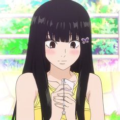 a girl with long black hair holding a cell phone