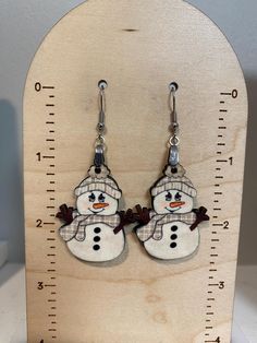 Check out these adorable snowman earrings! These earrings are made using  sublimation ink  - the snowman design is  heat pressed onto one side of the precut wood and permanent - no faux leather or vinyl is used The earrings are lightweight with an approximate 2" drop with a width of approximately 1" Perfect  accessory for the winter season or any snowman lover! Please feel free to contact me with any questions! Snowman Earrings, Snowman Design, Winter Earrings, Earrings Wood, Earrings Christmas, The Snowman, Sublimation Ink, Cute Snowman, Earrings White