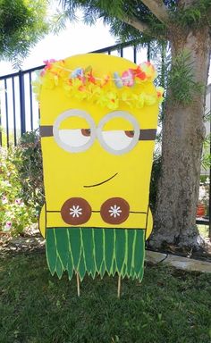 a cardboard cut out of a cartoon character with flowers on it's head sitting in the grass