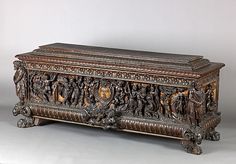 an ornate wooden box with carvings on it