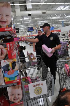 a police officer pushing a shopping cart in a store